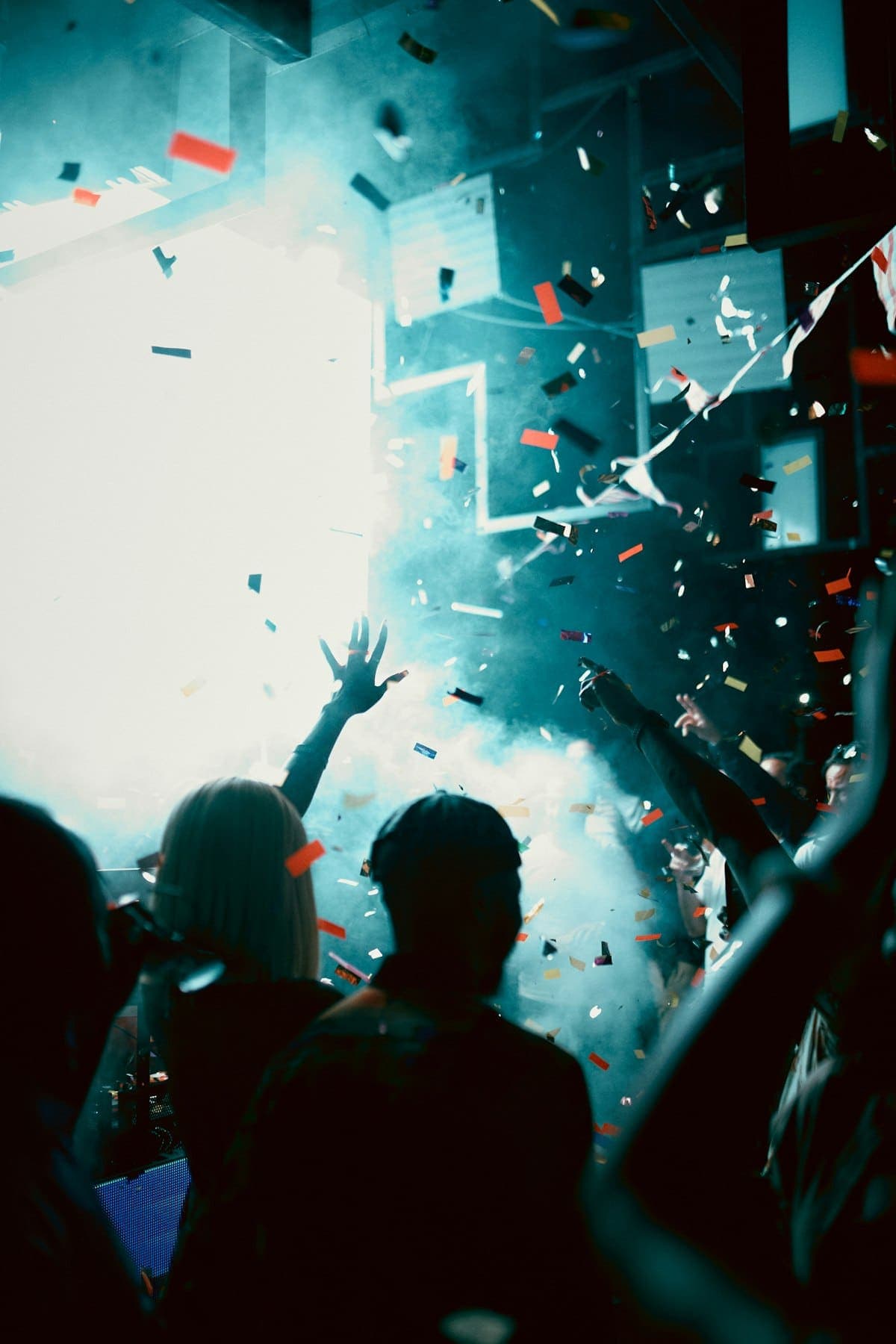 Confetti falling over a crowd under stage lights