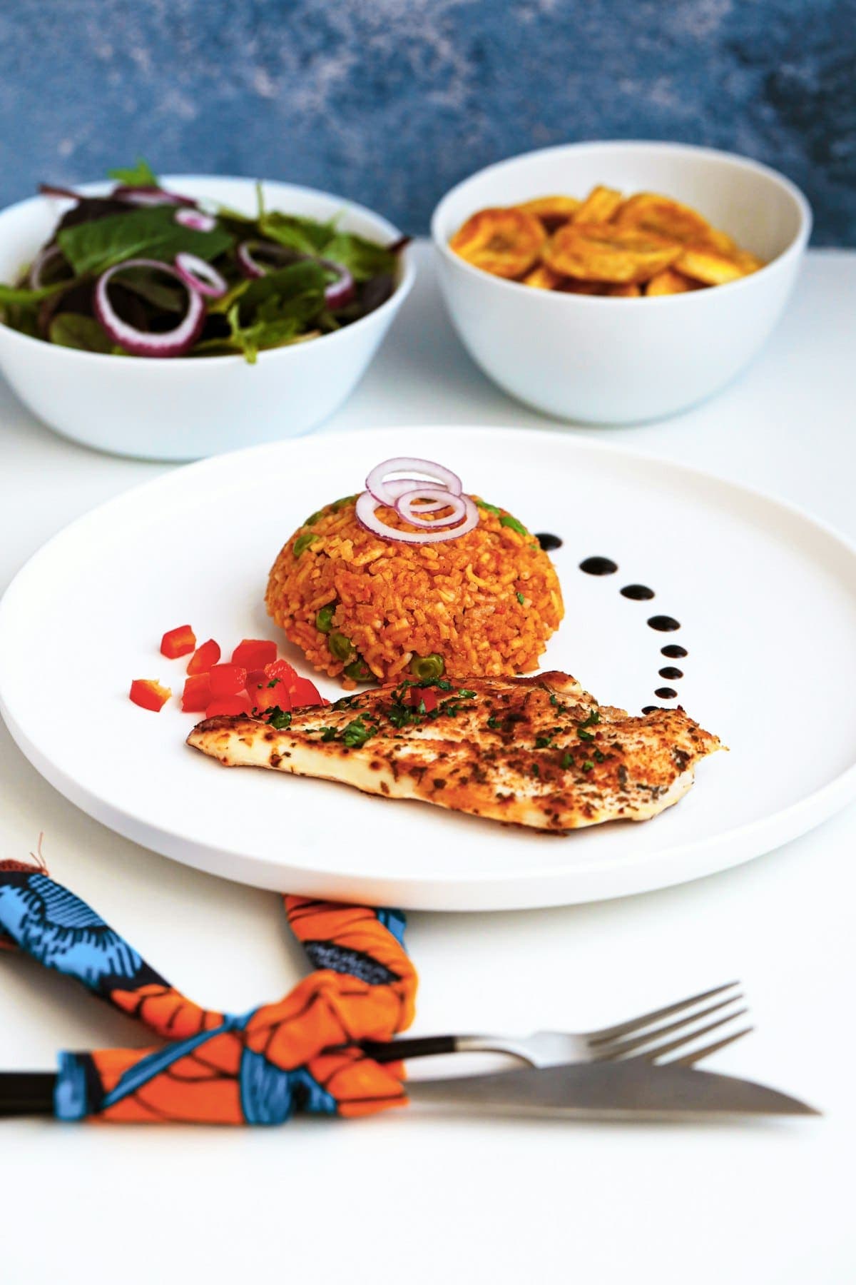 Jollof rice with grilled chicken and fried plantain